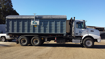 Coastal Rolloff truck with rolloff container attached. 